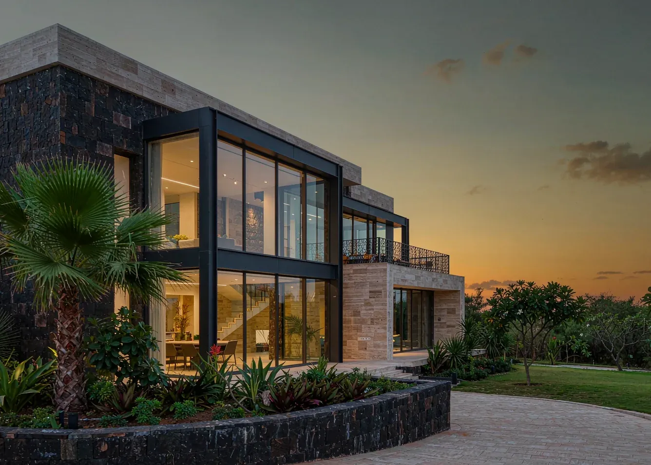 Contemporary villa exterior with floor-to-ceiling slim aluminium windows at dusk