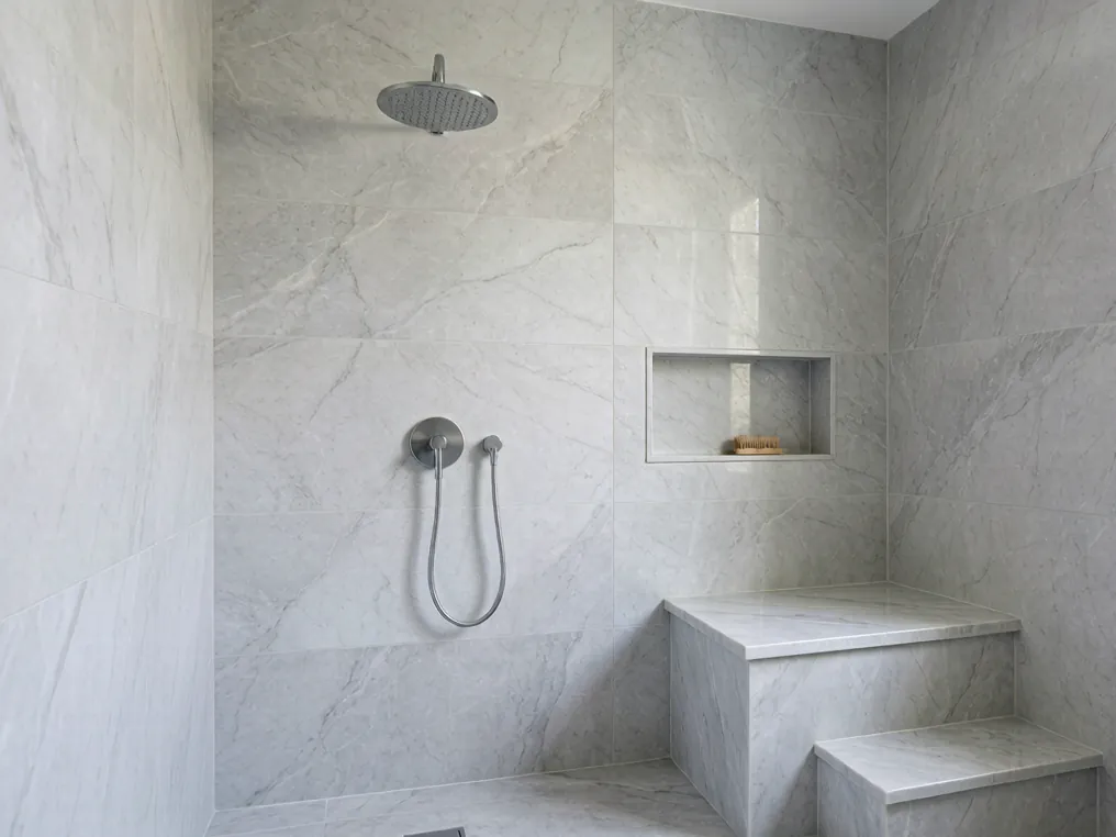 Walk-in shower renovation idea with rainfall showerhead and marble tiles
