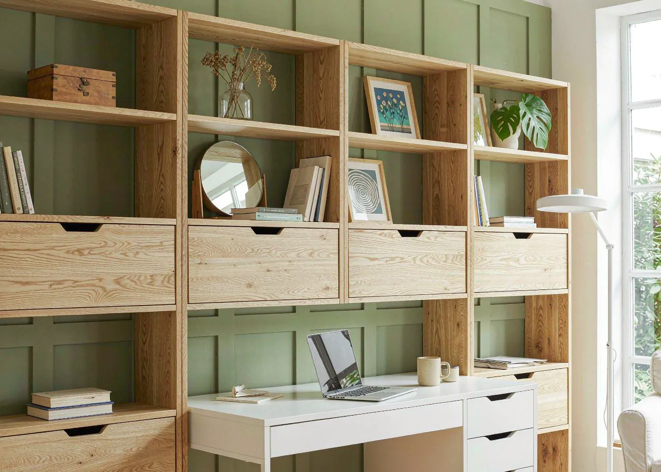 Modern home office with oak shelving and monstera