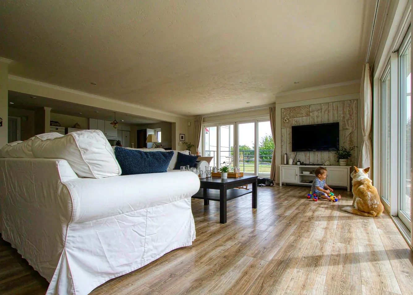 Family room with waterproof SPC vinyl plank flooring and a dog