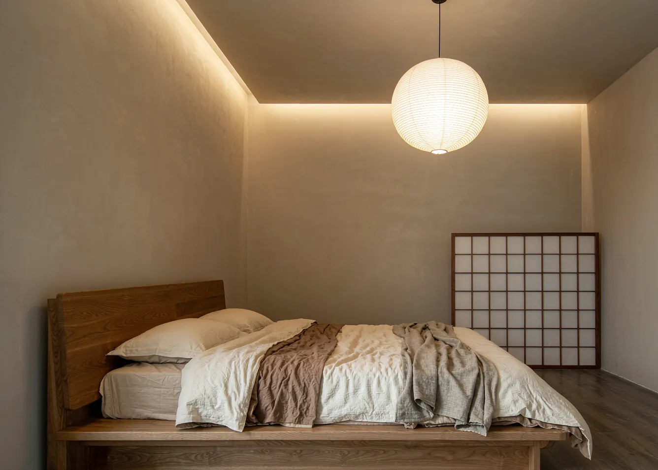 Japandi bedroom trend with low wooden platform bed and warm lighting