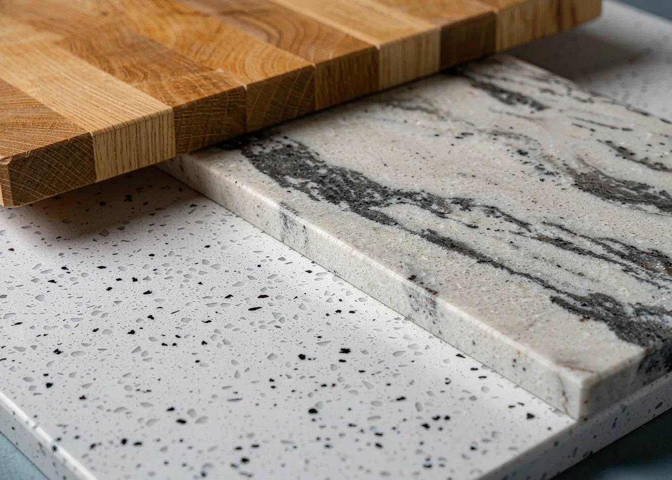 Quartz, marble and wood countertop samples used consistently across open plan zones