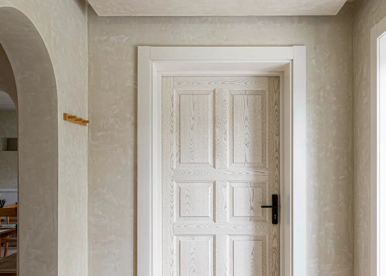 modern white oak prehung 36 inch door in a bright minimalist interior