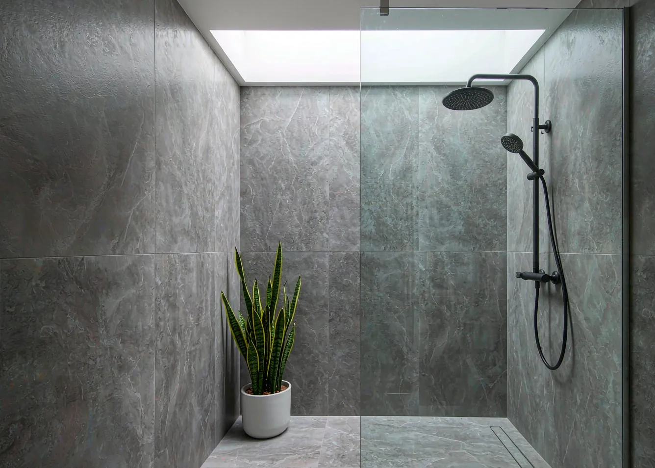 Modern minimalist bathroom with skylight and low-flow shower
