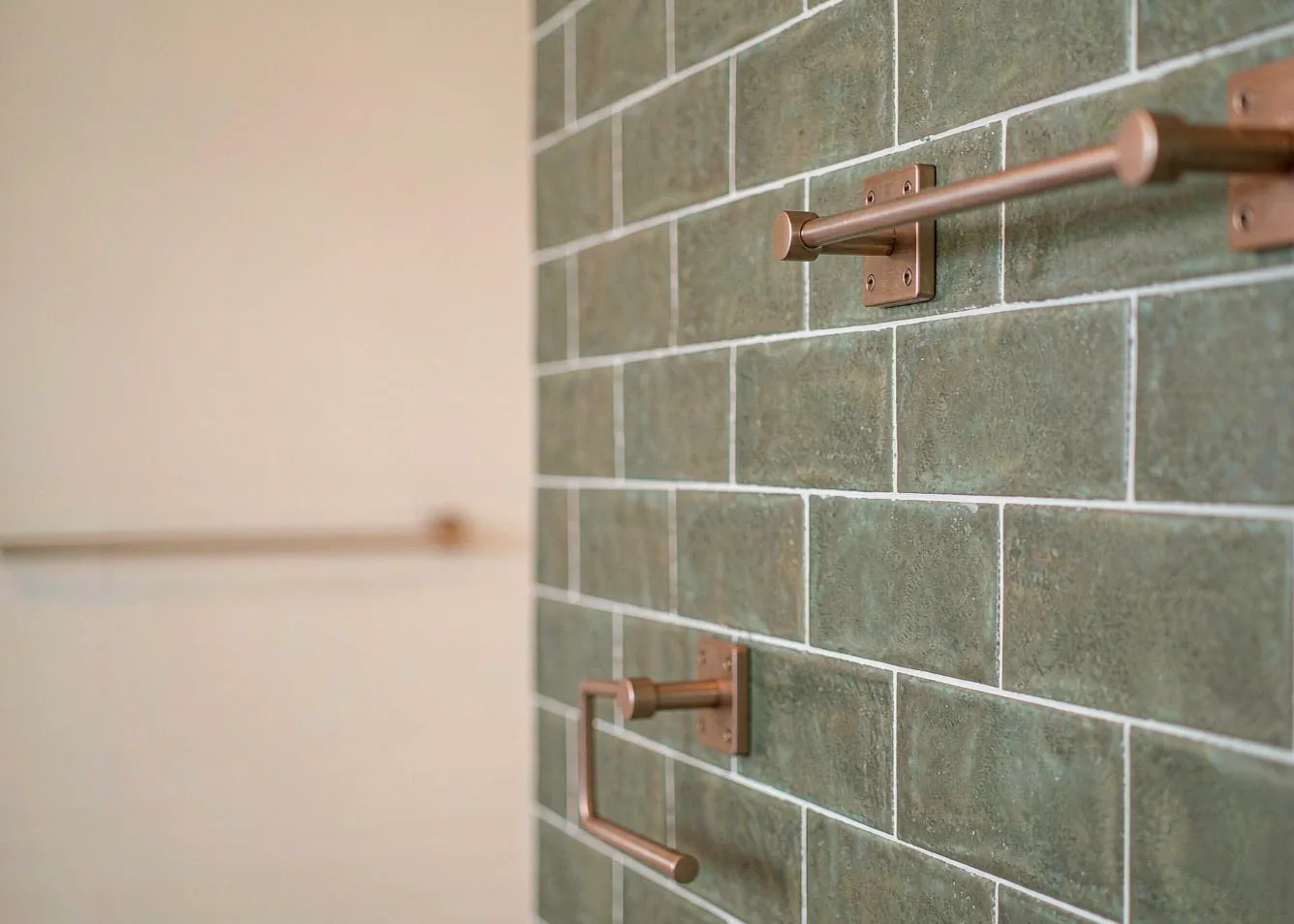 Matte sage green subway tiles in a modern small bathroom